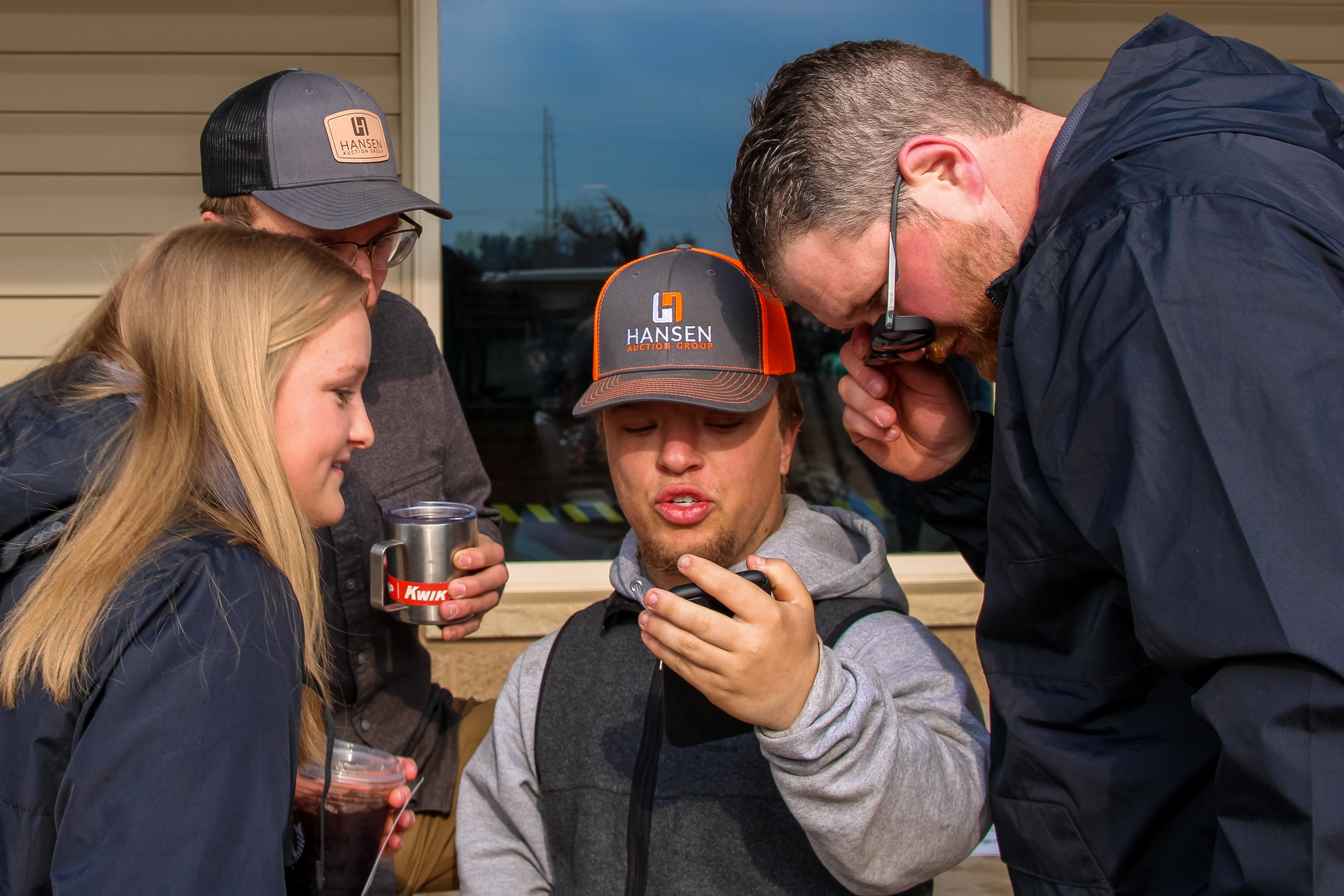 Group of people looking at cell phone