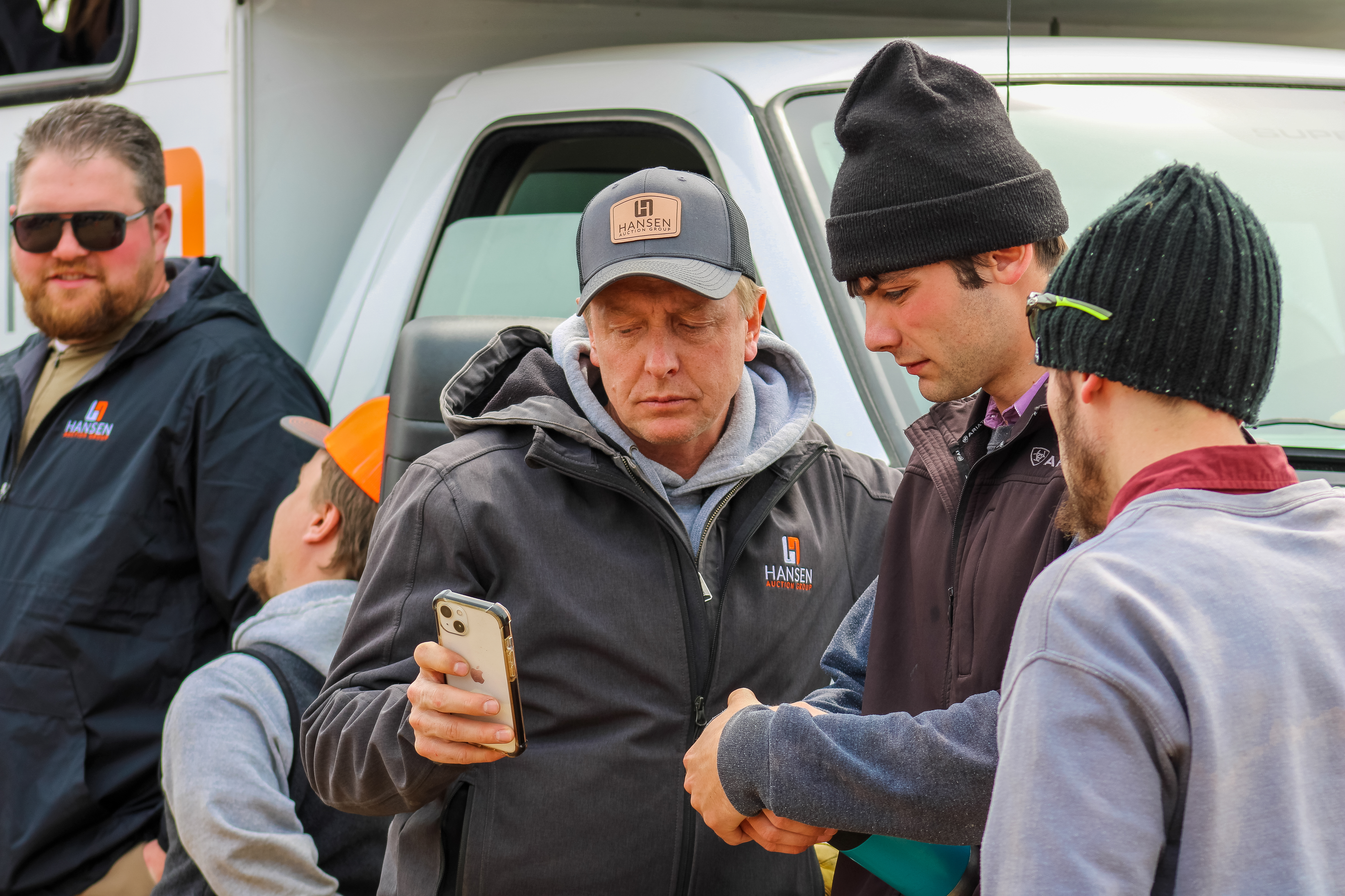 Group of young men looking at cell phone